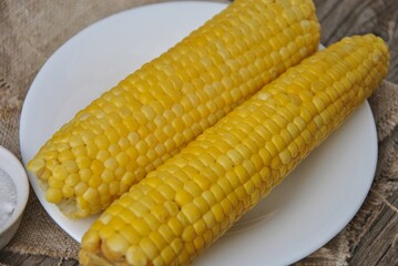 boiled corn on a plate close-up. selective focus. delicious boiled corn on a white plate