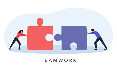 Business people pushing huge pieces of one puzzle towards each other. Teamwork concept.