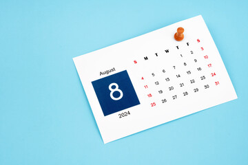 August 2024 calendar page with push pin on blue background.
