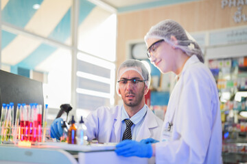 scientists perform experiments and record data. people arranges equipment with test tubes and chemicals for producing medicine and biochemistry. man hold tubes of chemical liquids and plant samples.
