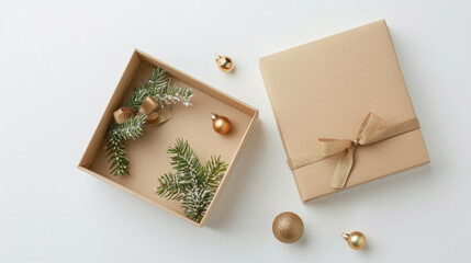 Gift box with Christmas decorations, isolated on a white background, top view of an open square box with a ribbon bow, pine branches, and golden decorations.