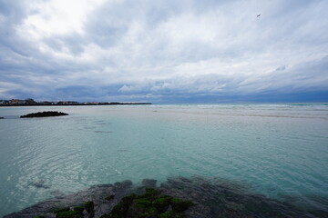 clear shoaling beach and far island