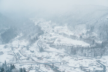 view of village with snow in winter from mountain viewpoint of Yamadera temple, the popular name...