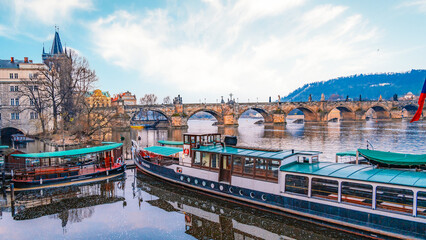 View of the city of Prague castle, boat trips and the Vltava river with Charles bridge in Prague, Czech Republic.