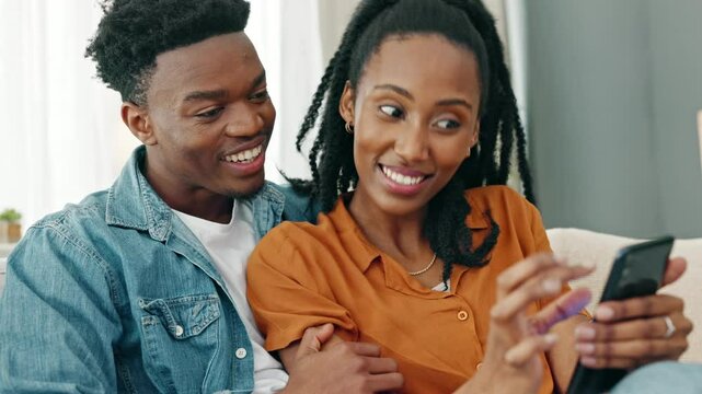 Home, smartphone and couple reading notification confirmation message, text or email and relax on a sofa. Black woman, man or people looking at social media content or an online digital ecommerce app