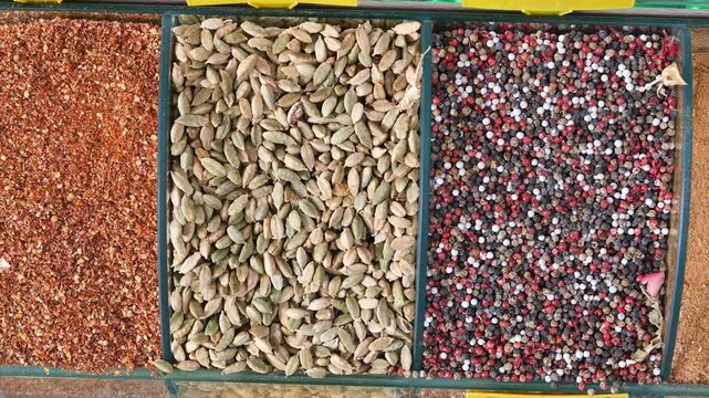 Vibrant seeds and spices displayed in the market, offering a colorful assortment for sale