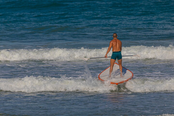 surfer in a board on the waves