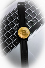 black bitcoin watch on a laptop keyboard