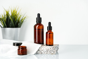 Amber Glass Bottles of Essential Oil on White Surface