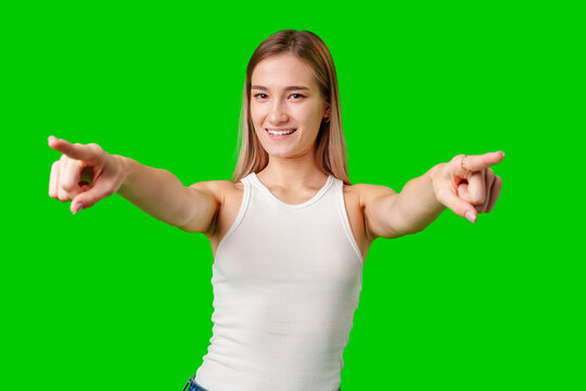 Young Woman Pointing Both Hands at Camera on Green Screen