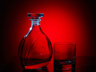 Decanter and glass on red closeup