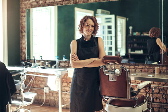 Smile, confidence and portrait of woman in barbershop with stylist, hairdresser and small business owner. Service, about us and female barber in salon with tools, pride and professional hair care