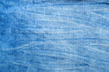 Blue denim jeans fabric texture with white worn lines, abstract backdrop