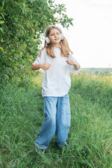 A child  with headphones listening to music and dancing