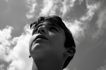 A surprised young male looking to the sky with a questioning or amazed expression.