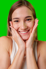 Portrait of a Happy Young Woman With Hands on Cheeks, Green Screen Background