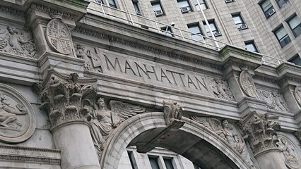 A close-up shot of the intricate architectural details of the Manhattan Arch. The image highlights the stone carvings and classic design elements of this historic structure in New York City.