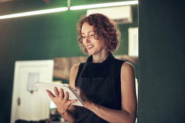 Happy, hairdresser and woman with tablet in salon for schedule, online appointment and calendar...