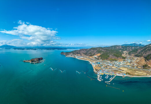 Aerial and winter view of Jeodo Island and Jukbangryeom(Bamboo Fishing Weir) on the sea with Silan Port of Silan-dong near Sacheon-si, South Korea
