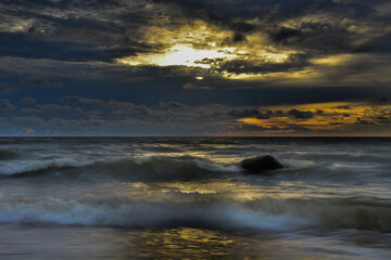 sunset over the  Baltic sea, cloudly sky