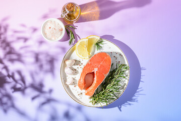 raw salmon with lemon and garlic on a plate