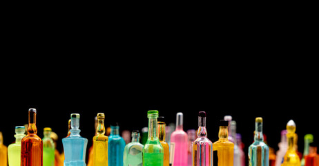 miniature resin drink bottles on dark background