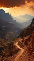Obraz premium A dirt road leading off into the distance to mountains on the horizon at sunset. 