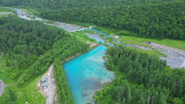 Biei, Hokkaido: Aerial drone footage of the famous Shirogane Blue Pond near Asahikawa in Central Hokkaido in Japan in summer. 