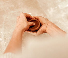 Hands, clay and pottery design in workshop with craft, shape and skills at small business. Person, artist and entrepreneur with material, creativity or manufacturing at startup factory for product