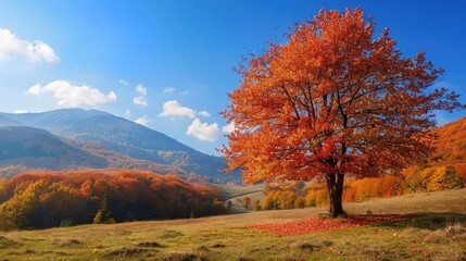 Scenic autumn landscape with a vibrant tree and mountain under a clear sky