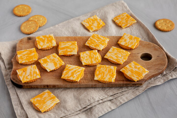 Easy Cheese and Crackers on a wooden board, side view.
