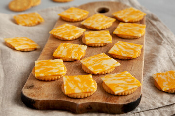 Easy Cheese and Crackers on a wooden board, side view.