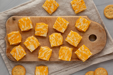 Easy Cheese and Crackers on a wooden board, top view. Flat lay, overhead, from above.