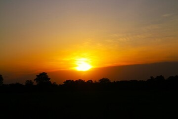 Sunset Sky Clouds in the evening with Red, Orange, Yellow and purple sunlight on Golden hour after sundown, Romantic sky in summer on Dusk Twilight. heart sky.