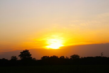 Sunset Sky Clouds in the evening with Red, Orange, Yellow and purple sunlight on Golden hour after sundown, Romantic sky in summer on Dusk Twilight. heart sky.