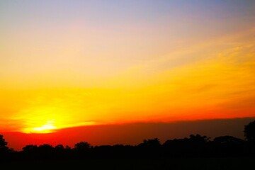 Obraz premium Sunset Sky Clouds in the evening with Red, Orange, Yellow and purple sunlight on Golden hour after sundown, Romantic sky in summer on Dusk Twilight. heart sky.