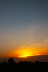 Sunset Sky Clouds in the evening with Red, Orange, Yellow and purple sunlight on Golden hour after sundown, Romantic sky in summer on Dusk Twilight. heart sky.