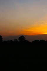 Sunset Sky cloud in the Morning Sunrise with Orange, Yellow Golden Hour Sunrise on Summer season, Horizon Dusk Sky Dramatic Nature Background