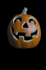 Halloween pumpkin with grinning face isolated on black background 