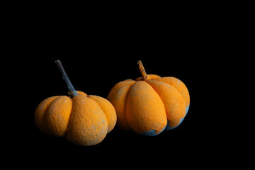 Two orange DIY pumpkins on a black background 