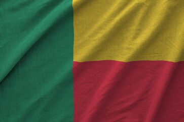 Benin flag depicted on folded wavy fabric of old cloth close up