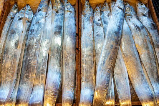 Close up of stacked raw silver cutlassfish at fish market of Seogwipo-si near Jeju-do, South Korea
