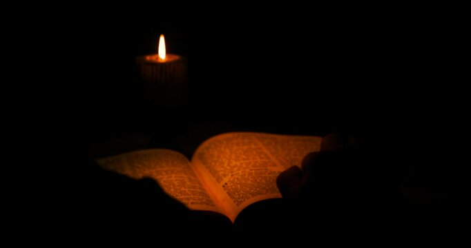 The Keeper Of The Castle In Ancient Times Reads Ancient Scriptures With A Burning Candle.