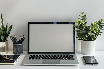 Fototapeta premium Workspace with open laptop, plants and stationary on desk