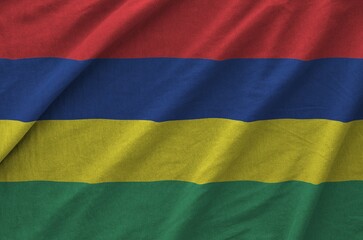 Mauritius flag depicted on folded wavy fabric of old cloth close up