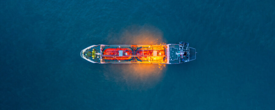 Aerial view Oil and Gas tanker ship LPG tanker ship transportation oil and gas from refinery on the sea at night, Oil and Gas tanker ship global business logistic refinery transportation.
