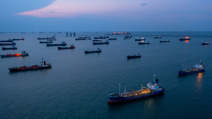 Fototapeta premium Aerial view Oil and Gas tanker ship LPG tanker ship transportation oil and gas from refinery on the sea at night, Oil and Gas tanker ship global business logistic refinery transportation.