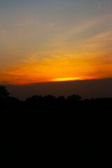 Sunset Sky cloud in the Morning Sunrise with Orange, Yellow Golden Hour Sunrise on Summer season, Horizon Dusk Sky Dramatic Nature Background