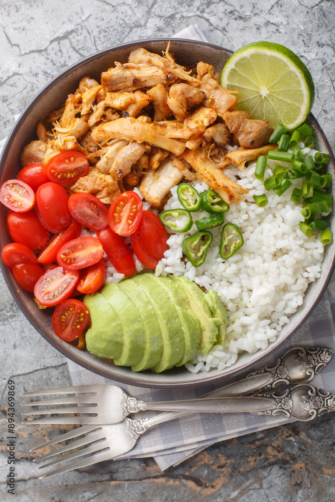 Canvas Prints bowl with pulled spicy chicken, rice, cherry tomatoes, avocado, jalapano pepper close-up on the tabl