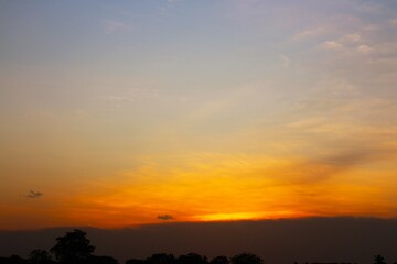 Fototapeta premium Sunset Sky cloud in the Morning Sunrise with Orange, Yellow Golden Hour Sunrise on Summer season, Horizon Dusk Sky Dramatic Nature Background